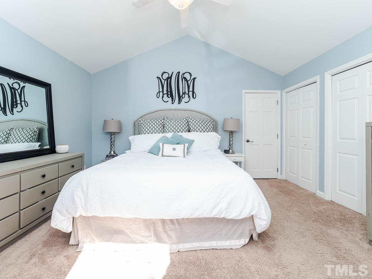 2002 Port Royal Road Raleigh, NC 27609 - Photo 10 of 23 a bedroom with a bed and a night stand