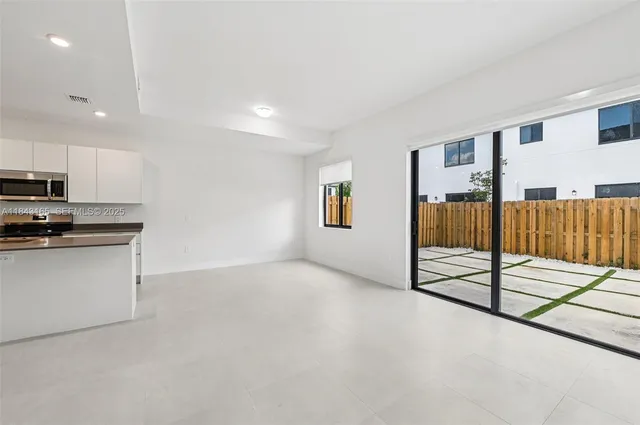 a view of a kitchen with a sink and cabinets