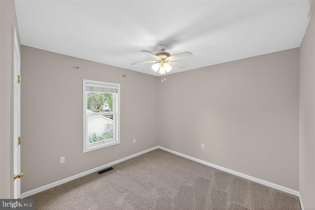 1604 Oriole Road Edgewater, MD 21037 - Photo 7 of 29 an empty room with windows and fan
