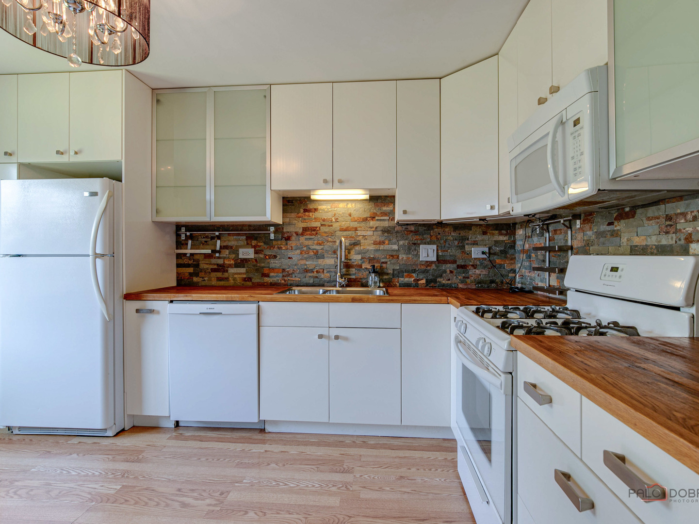 1082 Pine Tree Circle North, Unit 1082 Buffalo Grove, IL 60089 - Photo 12 of 26 a kitchen with granite countertop a stove a sink dishwasher and a refrigerator