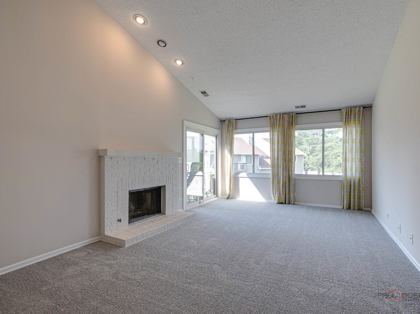 1082 Pine Tree Circle North, Unit 1082 Buffalo Grove, IL 60089 - Photo 6 of 26 a view of an empty room with a fireplace and a window