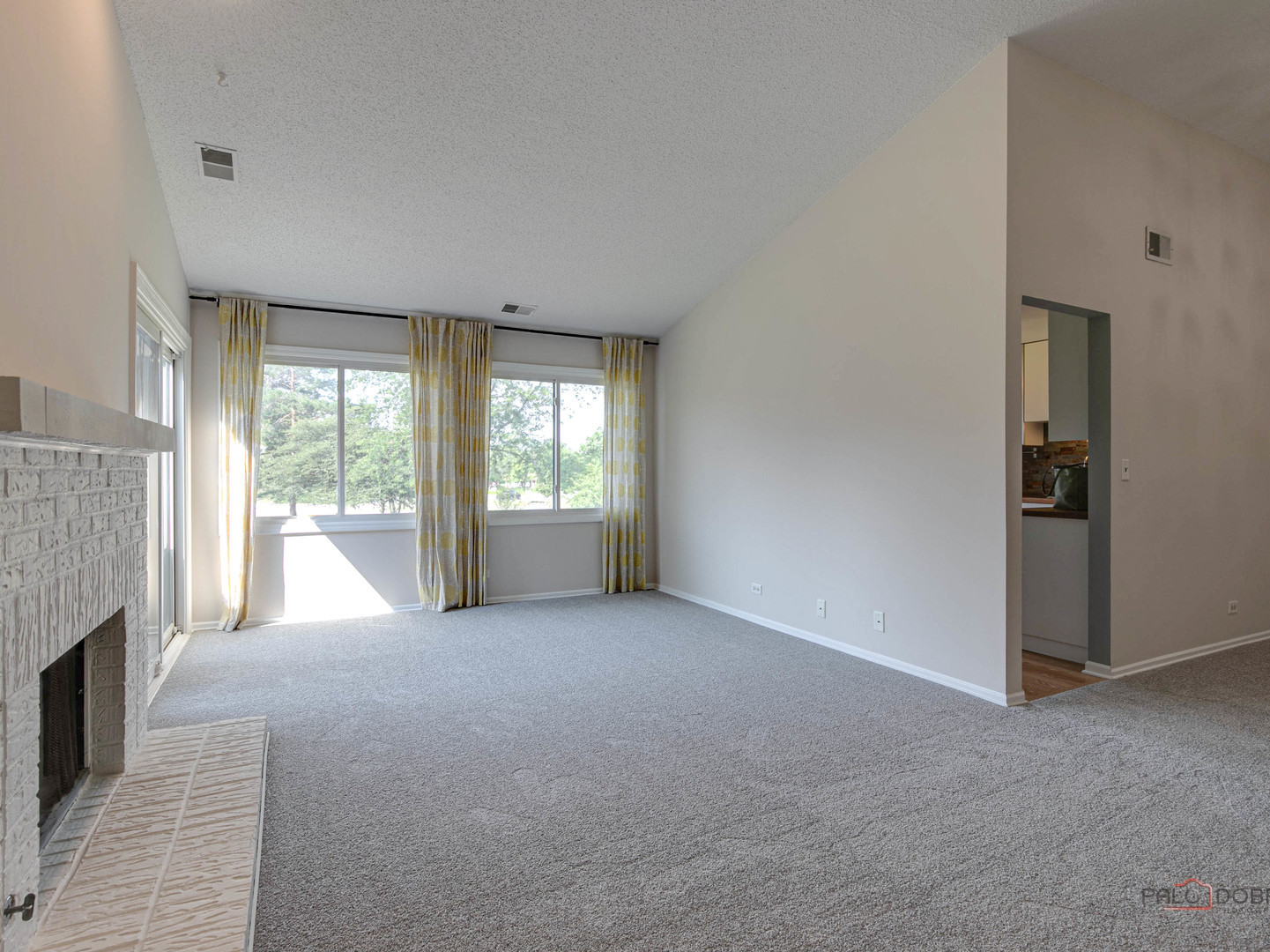 1082 Pine Tree Circle North, Unit 1082 Buffalo Grove, IL 60089 - Photo 7 of 26 an empty room with windows and fireplace