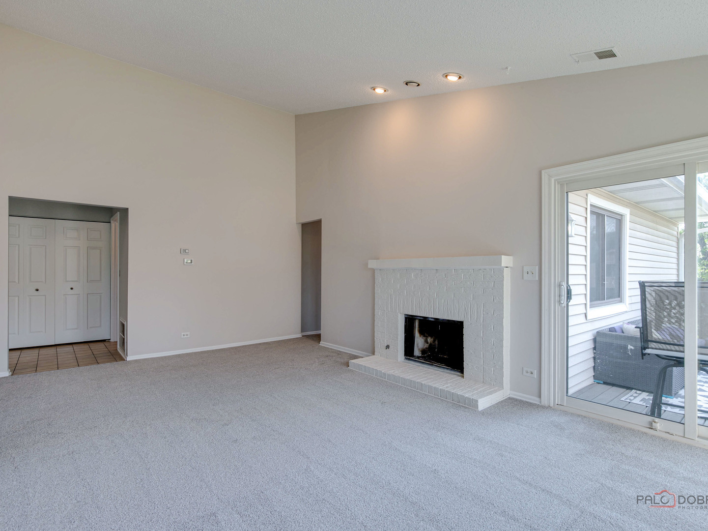 1082 Pine Tree Circle North, Unit 1082 Buffalo Grove, IL 60089 - Photo 8 of 26 an empty room with furniture and a fireplace