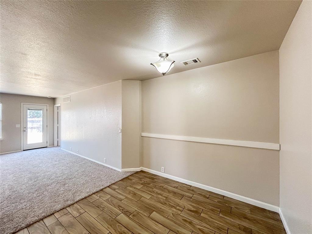 9013 Sagebrush Trail Cross Roads, TX 76227 - Photo 13 of 22 a view of empty room with wooden floor and fan