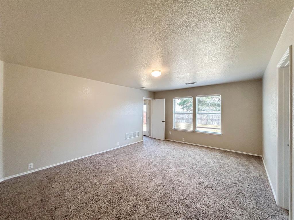 9013 Sagebrush Trail Cross Roads, TX 76227 - Photo 18 of 22 an empty room with windows