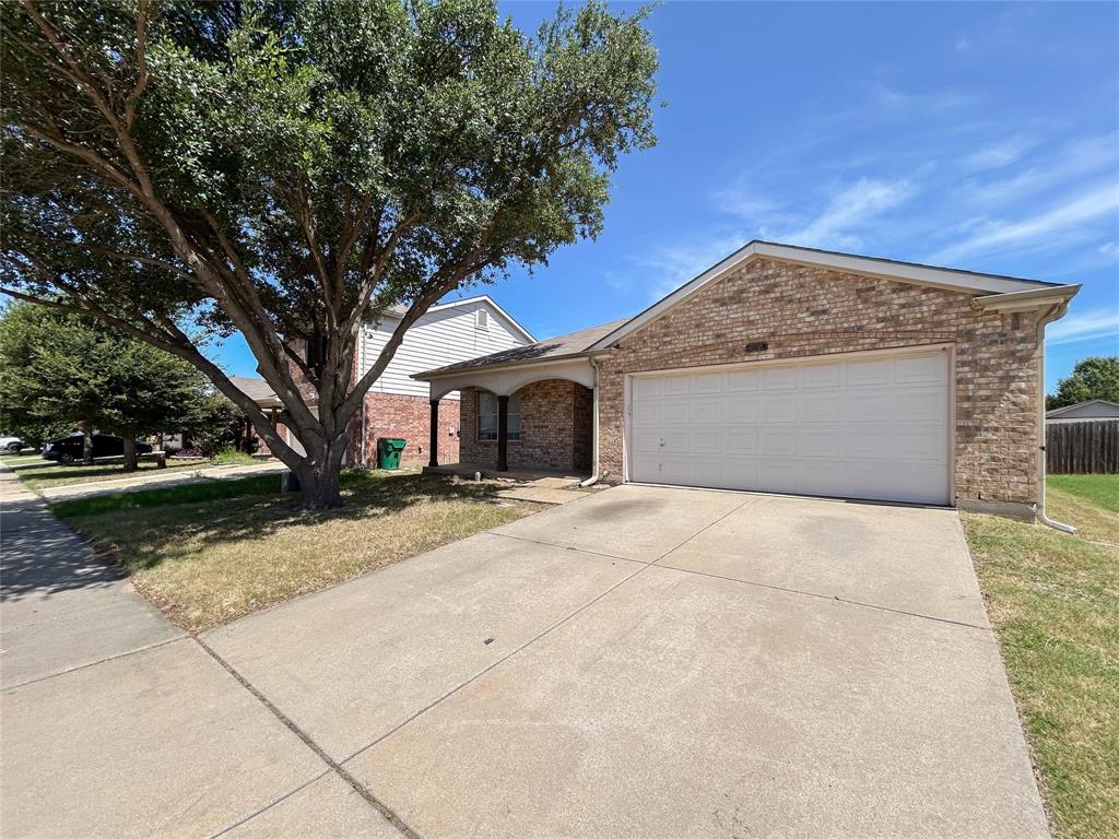 9013 Sagebrush Trail Cross Roads, TX 76227 - Photo 2 of 22 a front view of a house with a yard and garage