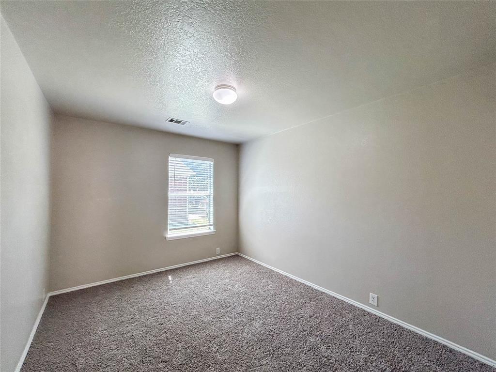 9013 Sagebrush Trail Cross Roads, TX 76227 - Photo 8 of 22 an empty room with a window