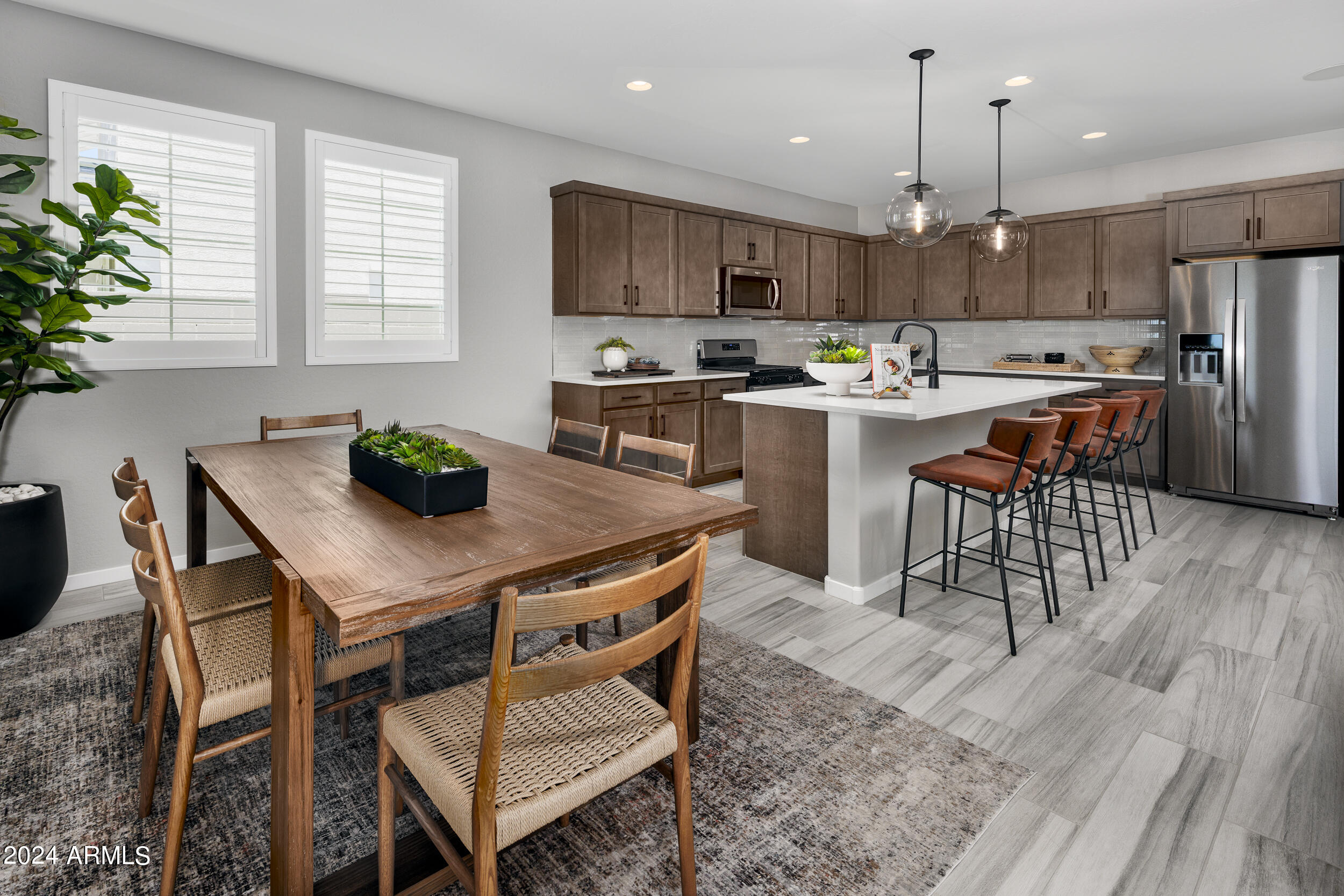 10274 South Dutchman Drive Apache Junction, AZ 85120 - Photo 6 of 45 a kitchen with a table chairs refrigerator and microwave