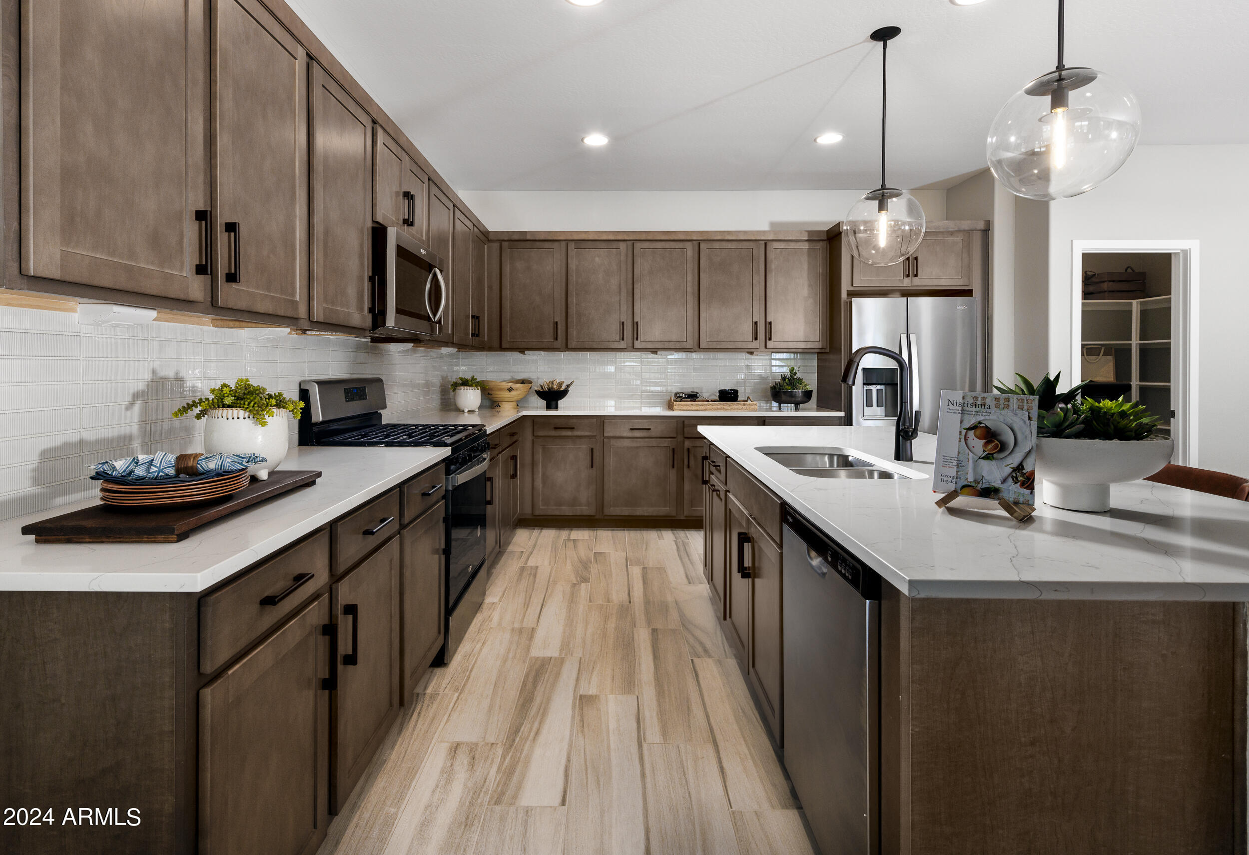 10274 South Dutchman Drive Apache Junction, AZ 85120 - Photo 7 of 45 a kitchen with kitchen island granite countertop a sink a counter space appliances and cabinets