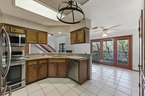 a kitchen with stainless steel appliances granite countertop a stove and a sink
