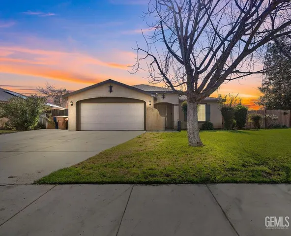 a bathroom with a granite countertop sink toilet a mirror and shower