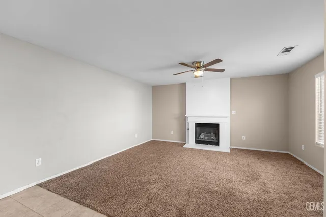 an empty room with a empty space and windows