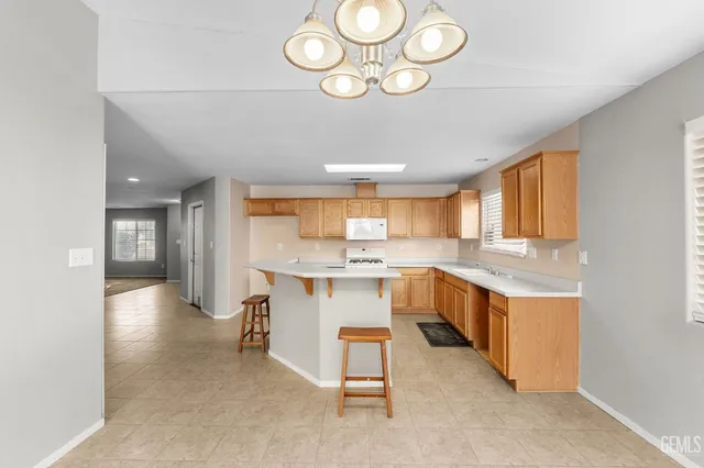 an empty room with windows and ceiling fan