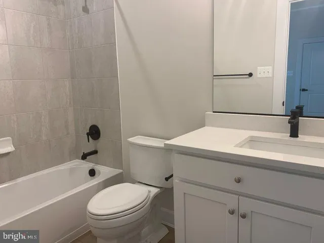 a bathroom with a sink a toilet and bathtub
