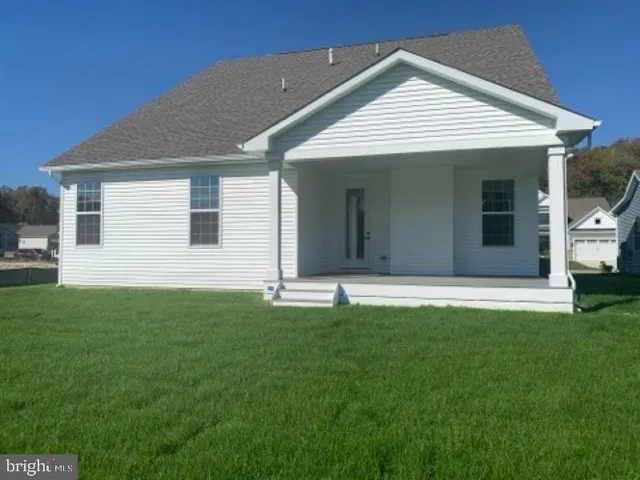 a front view of a house with a garden and yard
