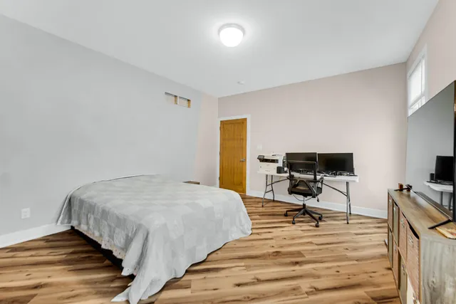 a bedroom with a bed a desk and chair