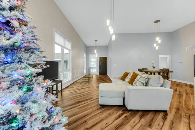 a living room with furniture and flowers