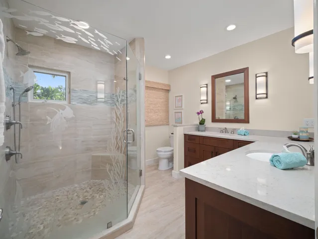 a spacious bathroom with a sink a toilet and shower