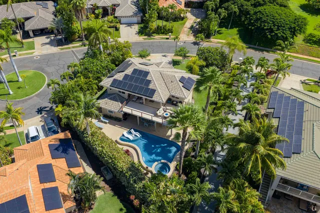 an aerial view of a house with a garden and swimming pool