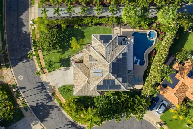 an aerial view of a house with a yard