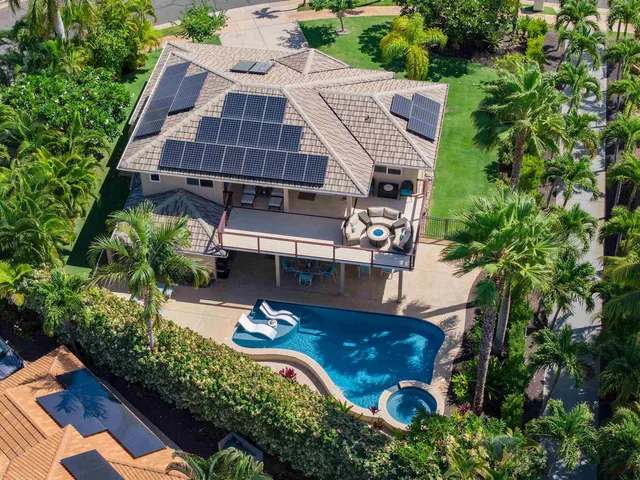 an aerial view of a house with garden space and street view
