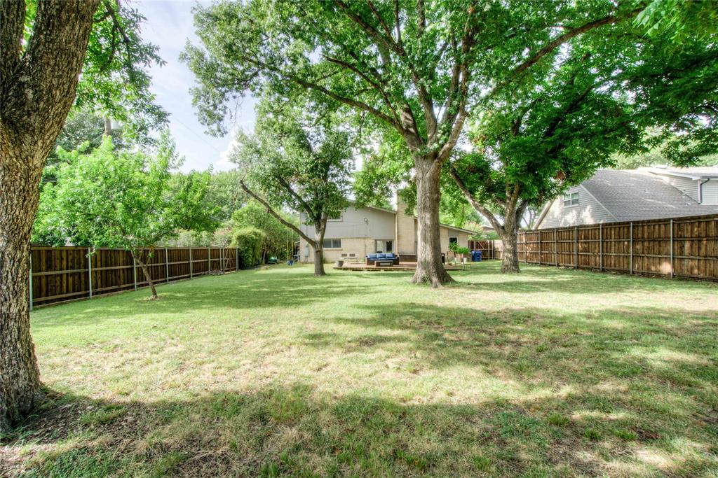12231 Veronica Road Farmers Branch, TX 75234 - Photo 25 of 26 Expansive grassy yard featuring mature trees providing shade