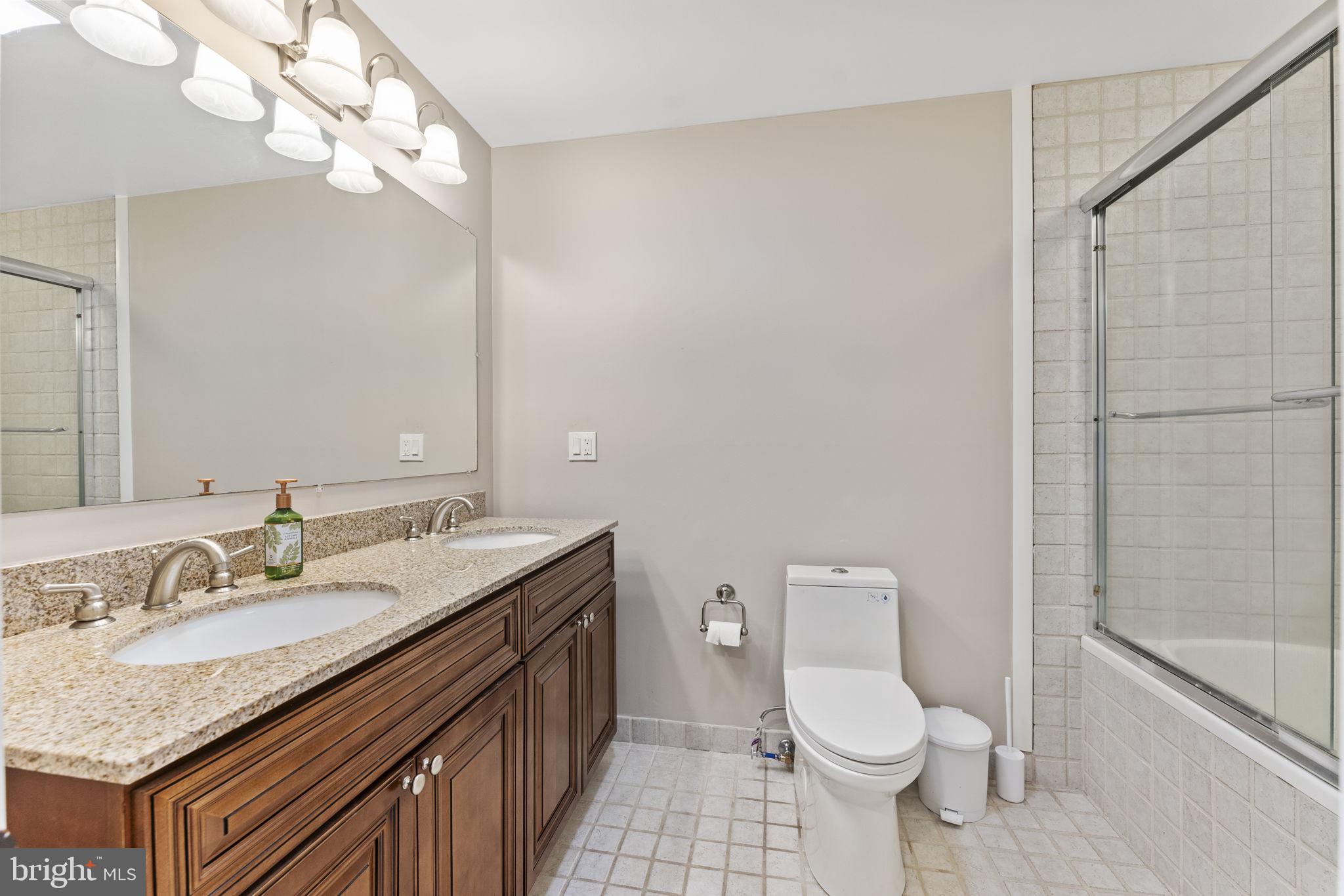 244 Mathers Road Ambler, PA 19002 - Photo 38 of 52 a bathroom with a granite countertop sink a toilet and a shower