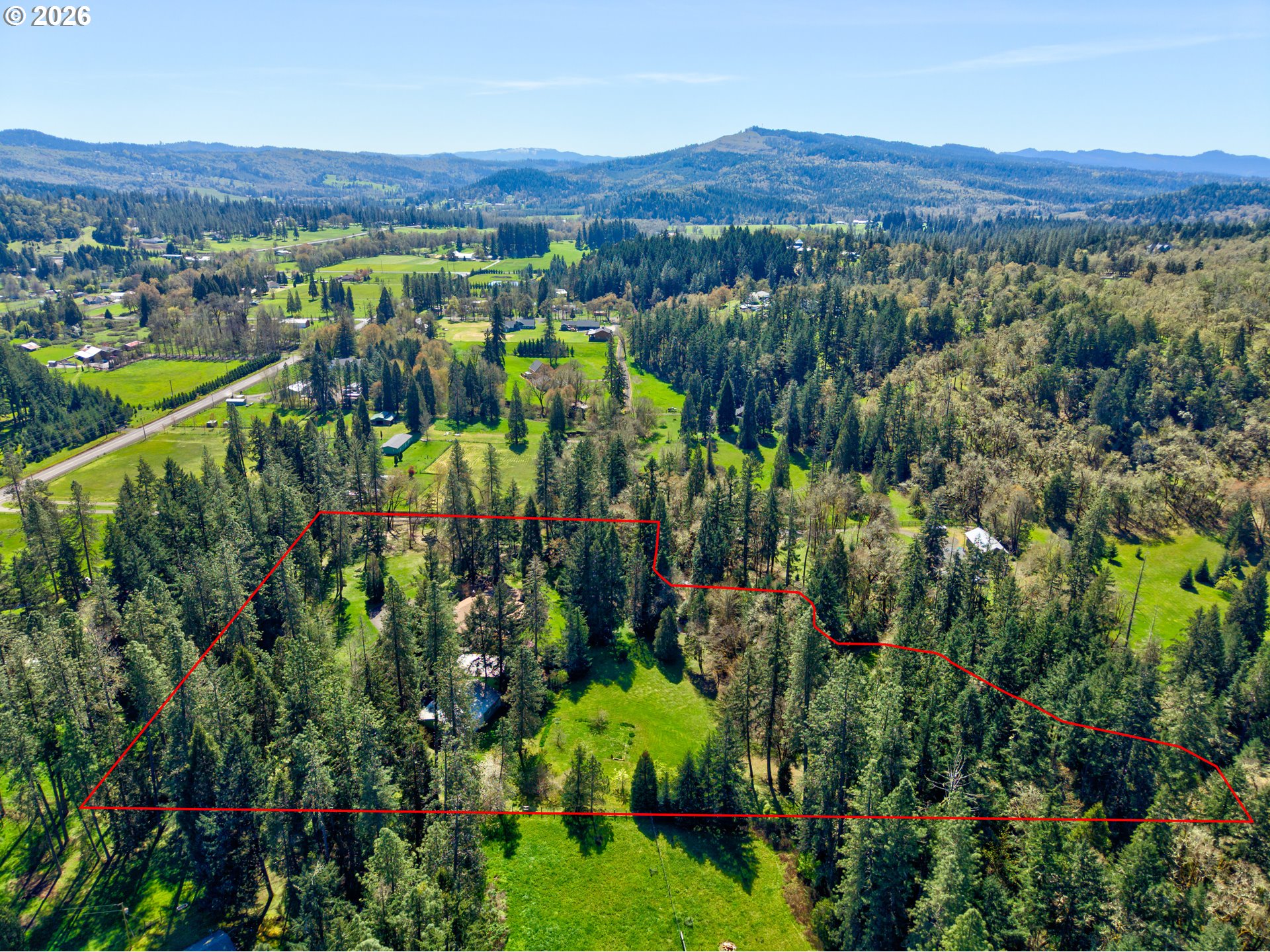 738 Elgarose Road Roseburg, OR 97471 - Photo 45 of 48 a view of a lush green field with mountains in the background
