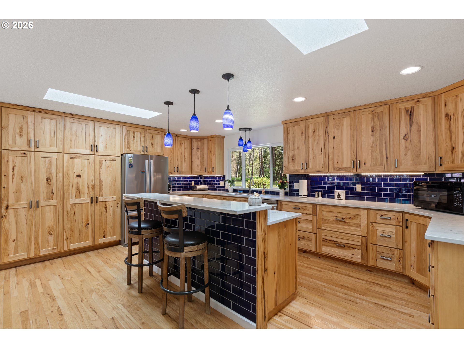 738 Elgarose Road Roseburg, OR 97471 - Photo 7 of 48 a kitchen with stainless steel appliances kitchen island granite countertop a table chairs sink and cabinets