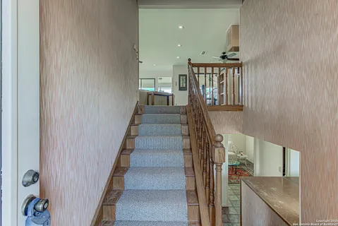 a view of entryway and hall with wooden floor