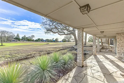 a view of a house with a yard and sitting area