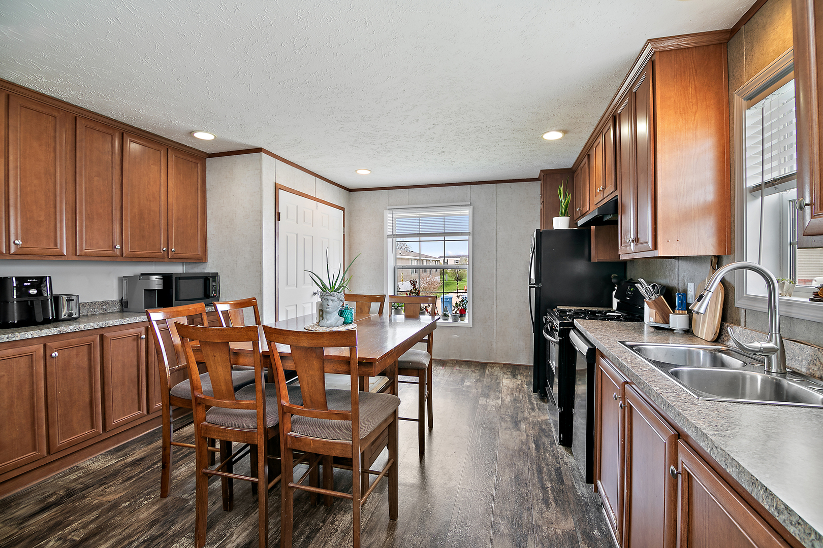 25 St Francis Drive Bourbonnais, IL 60914 - Photo 5 of 11 a view of a kitchen with a dining table chairs and a sink