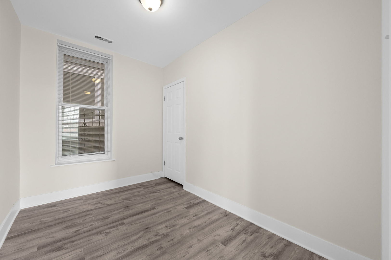 2756 West Monroe Street Chicago, IL 60612 - Photo 11 of 52 a view of an empty room with wooden floor and a window