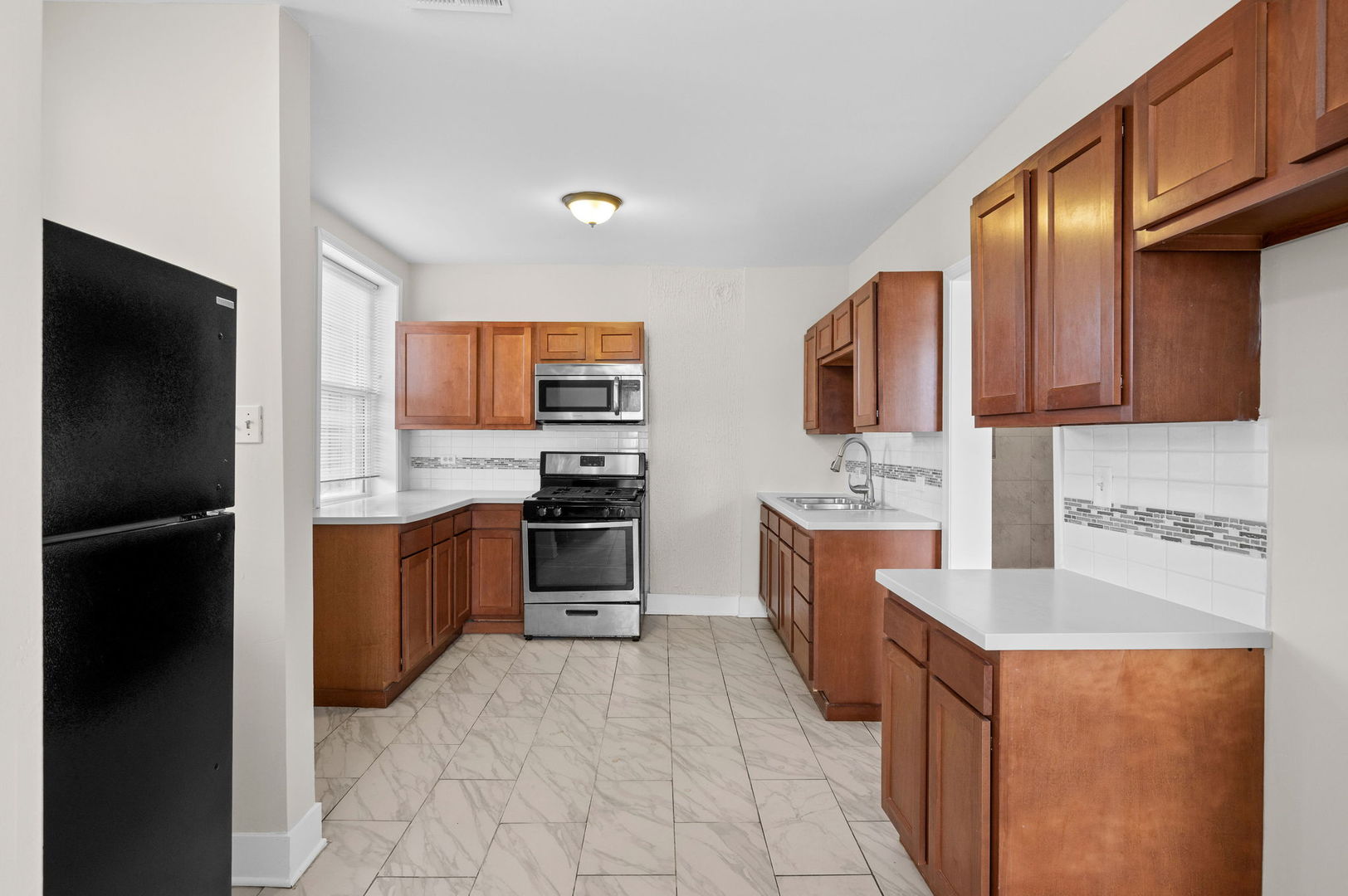 2756 West Monroe Street Chicago, IL 60612 - Photo 13 of 52 a large kitchen with stainless steel appliances granite countertop a refrigerator stove and sink