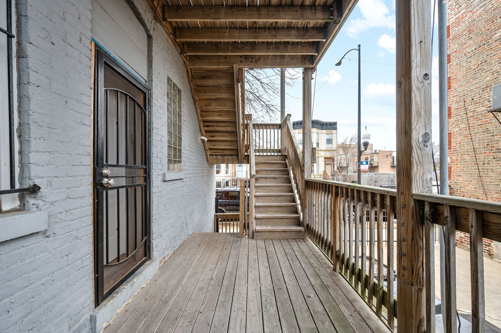 2756 West Monroe Street Chicago, IL 60612 - Photo 16 of 52 a view of a balcony with wooden floor and iron stairs