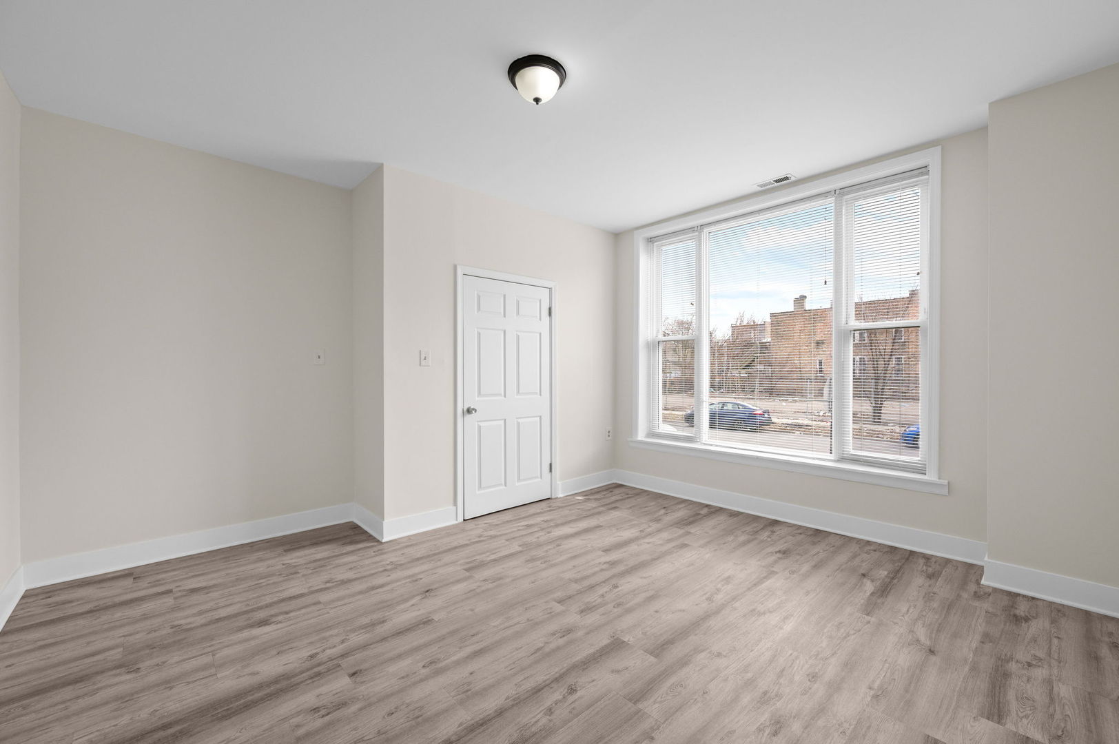 2756 West Monroe Street Chicago, IL 60612 - Photo 4 of 52 a view of an empty room with wooden floor and a window