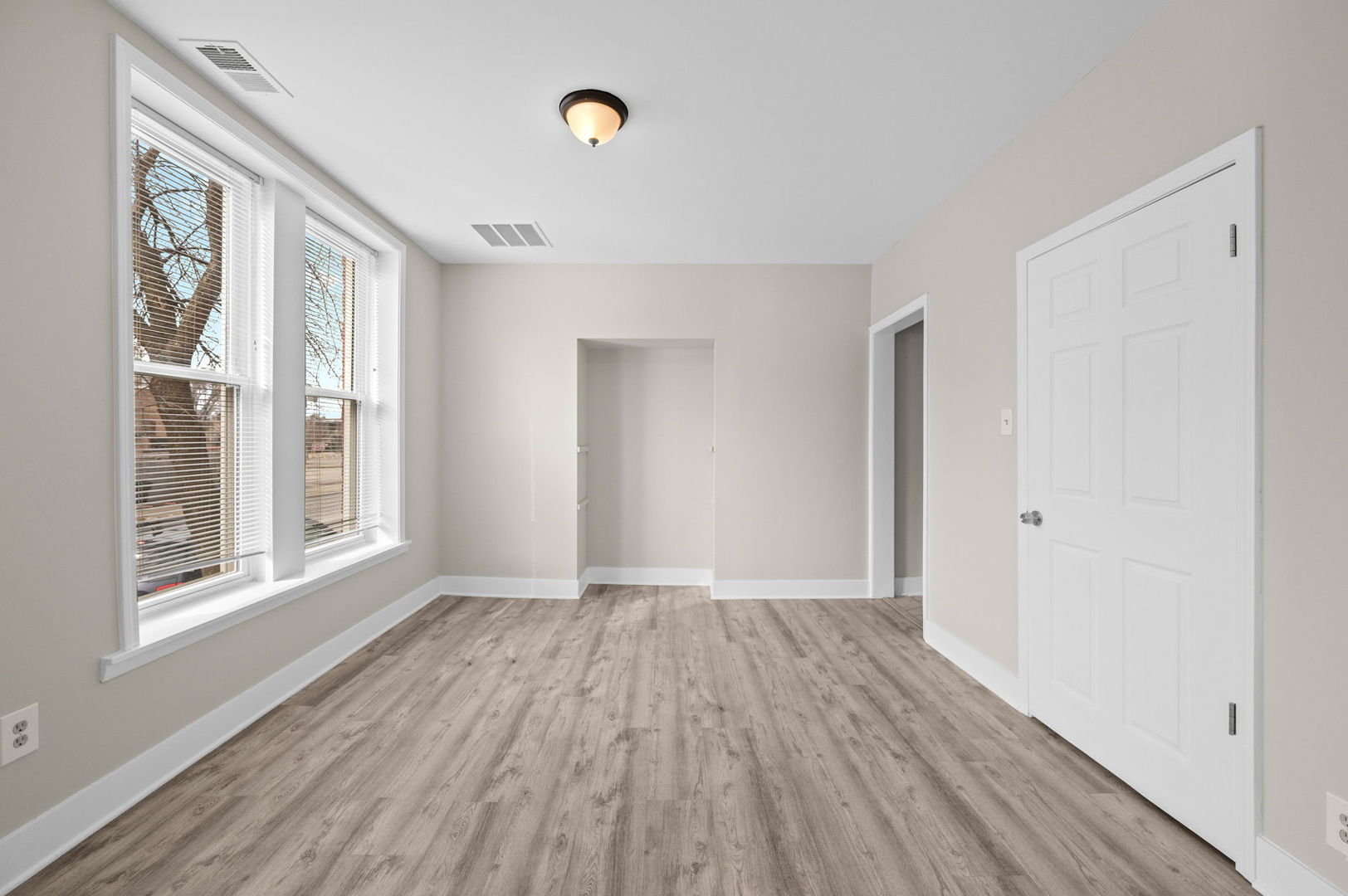 2756 West Monroe Street Chicago, IL 60612 - Photo 7 of 52 a view of an empty room with wooden floor and a window
