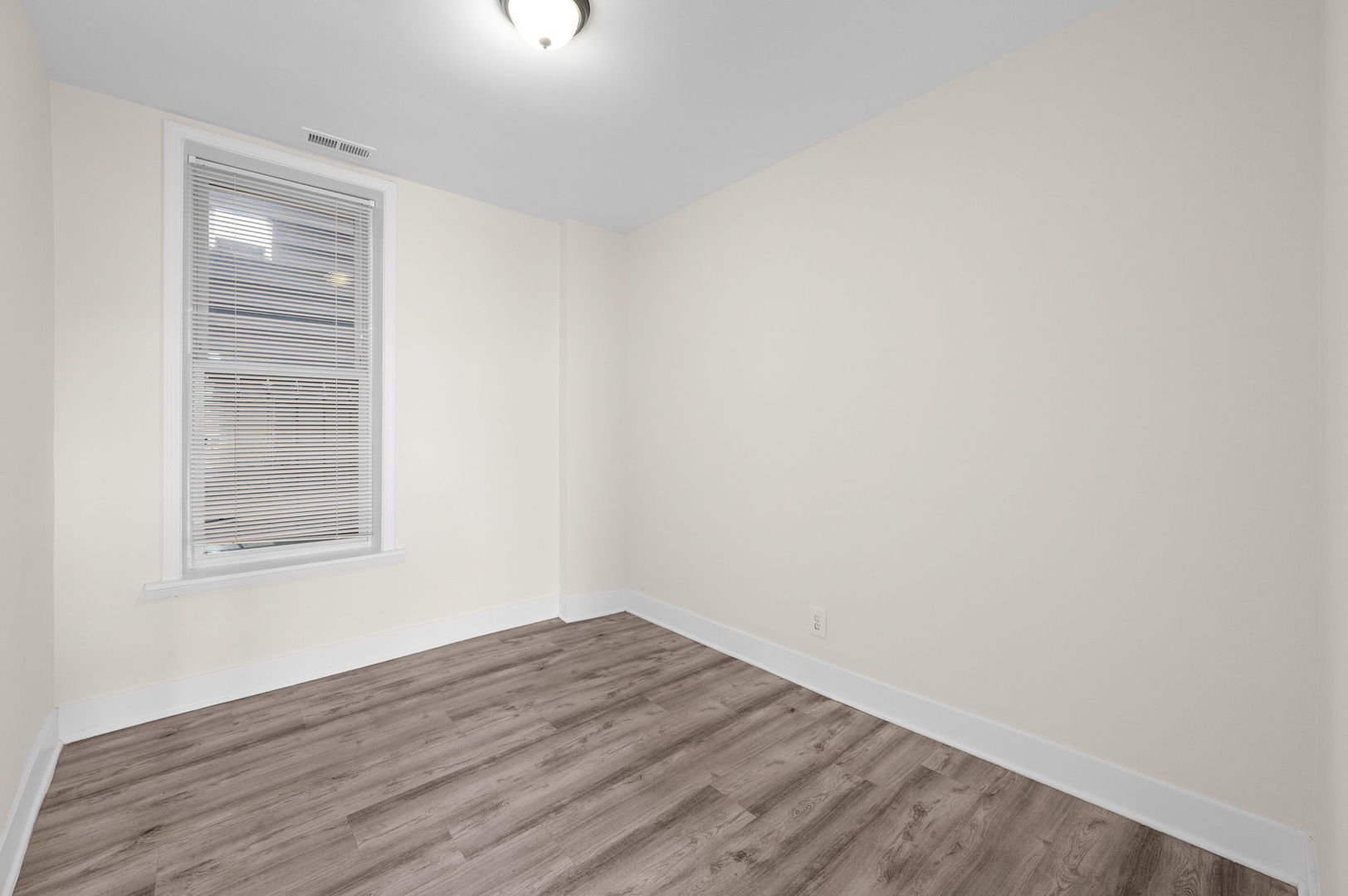 2756 West Monroe Street Chicago, IL 60612 - Photo 9 of 52 a view of an empty room with wooden floor and a window