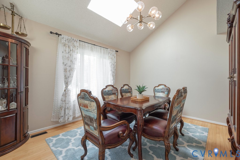 2602 Cox Road Henrico, VA 23233 - Photo 12 of 50 a view of a dining room with furniture and chandelier