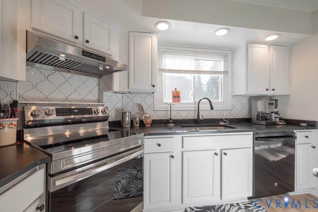 2602 Cox Road Henrico, VA 23233 - Photo 15 of 50 a kitchen with granite countertop a stove a sink and cabinets
