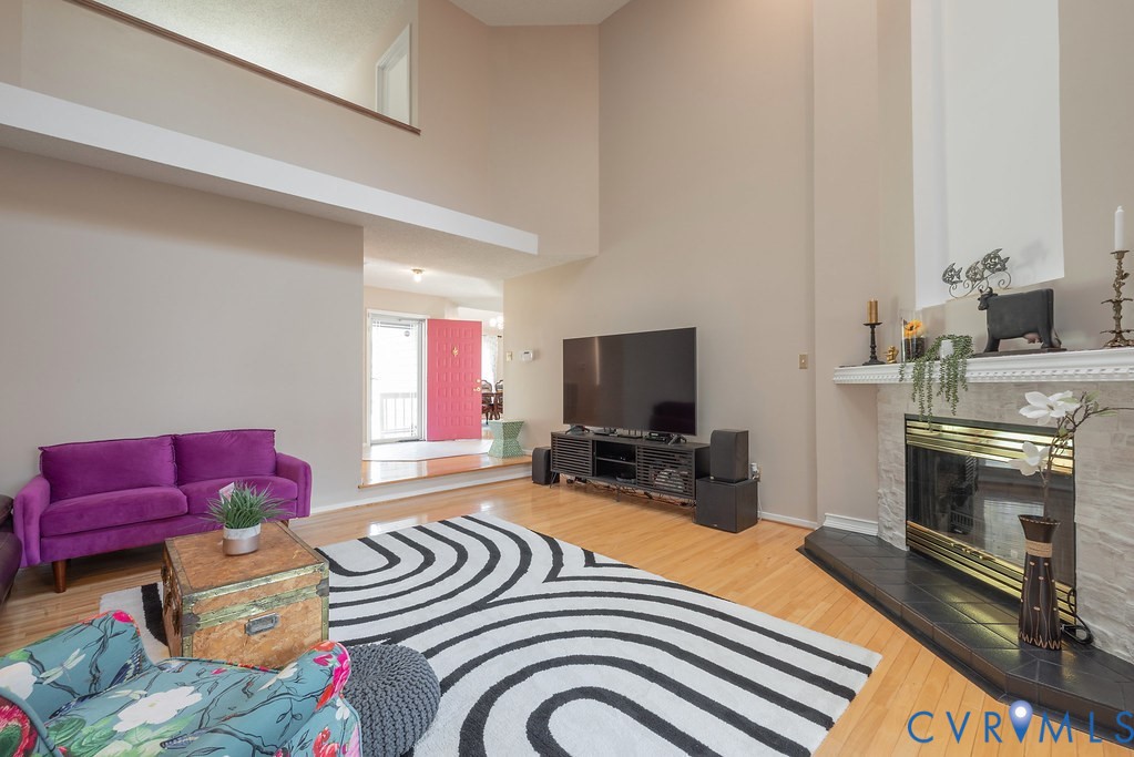 2602 Cox Road Henrico, VA 23233 - Photo 19 of 50 a bedroom with furniture a flat screen tv and a fireplace