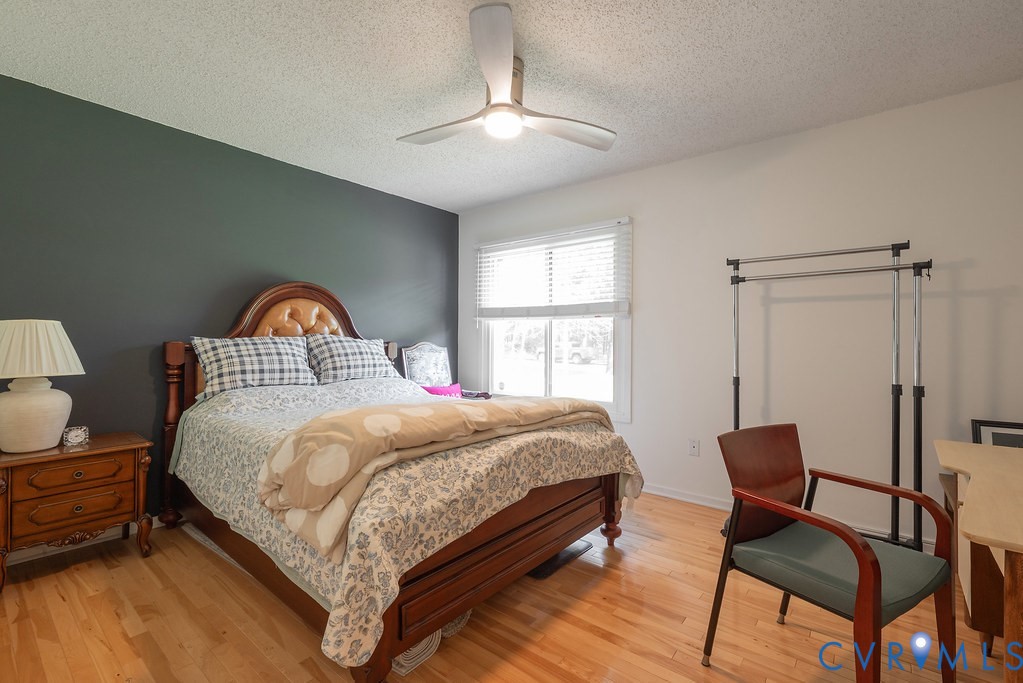 2602 Cox Road Henrico, VA 23233 - Photo 24 of 50 a bedroom with a bed and a chandelier