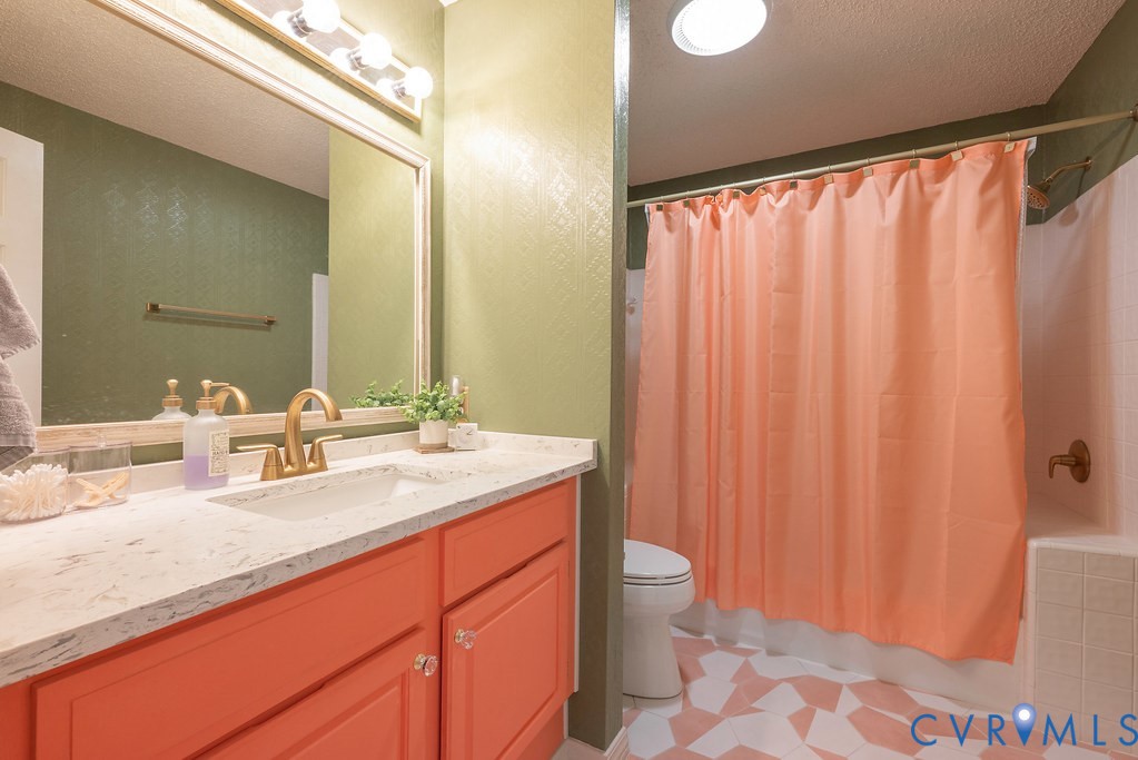 2602 Cox Road Henrico, VA 23233 - Photo 25 of 50 a bathroom with a granite countertop sink and a mirror