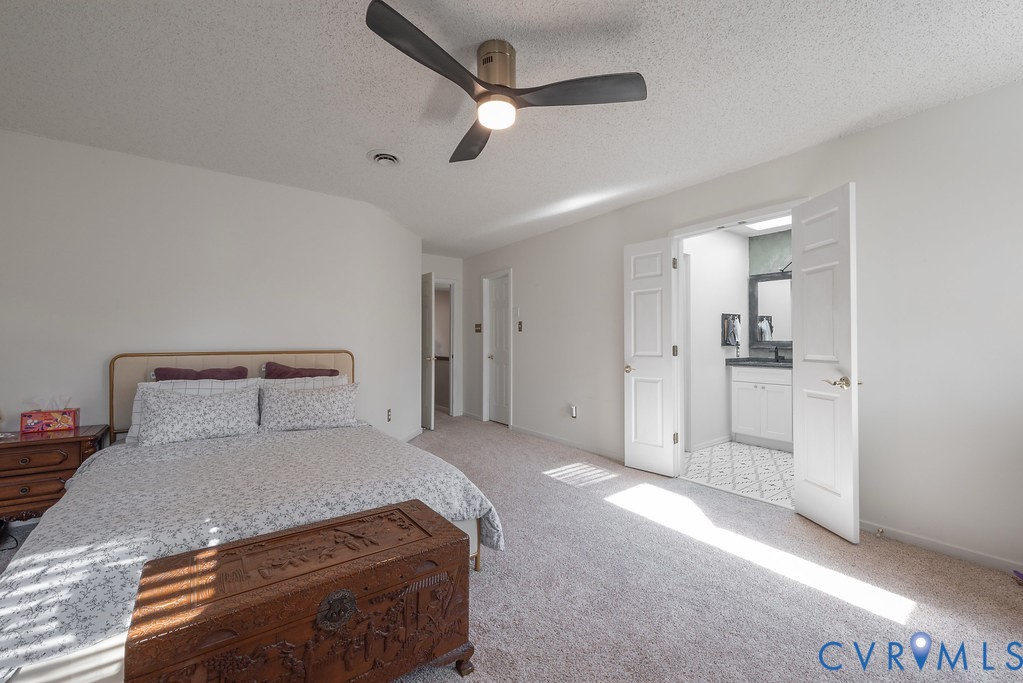 2602 Cox Road Henrico, VA 23233 - Photo 27 of 50 a bed room with a bed and a ceiling fan