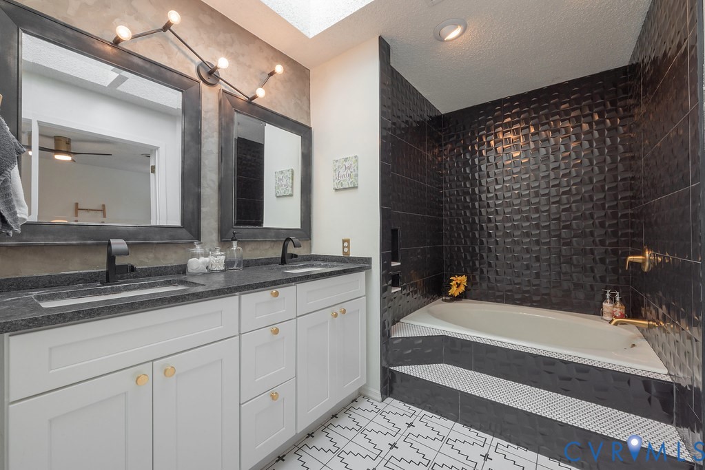 2602 Cox Road Henrico, VA 23233 - Photo 30 of 50 a bathroom with a bathtub and a sink