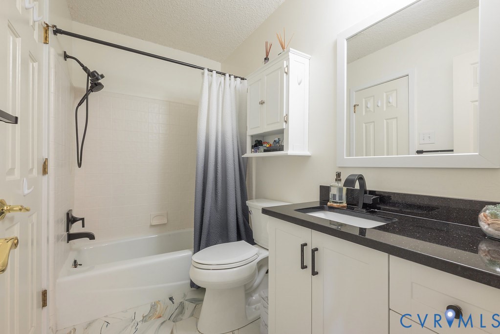 2602 Cox Road Henrico, VA 23233 - Photo 35 of 50 a bathroom with a granite countertop sink mirror toilet and bathtub