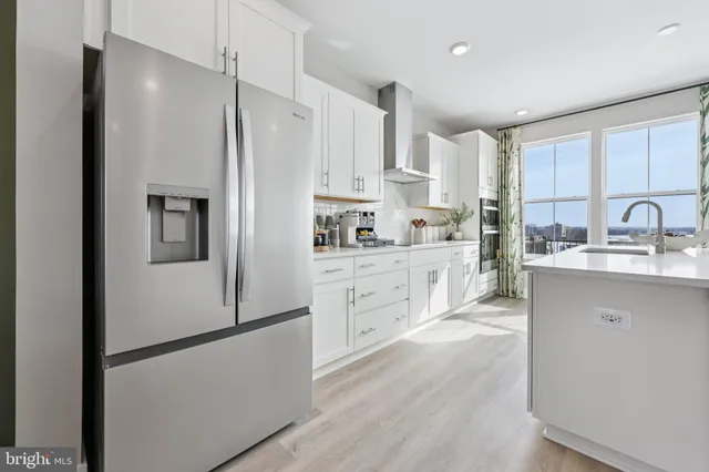 a kitchen with white cabinets and white stainless steel appliances