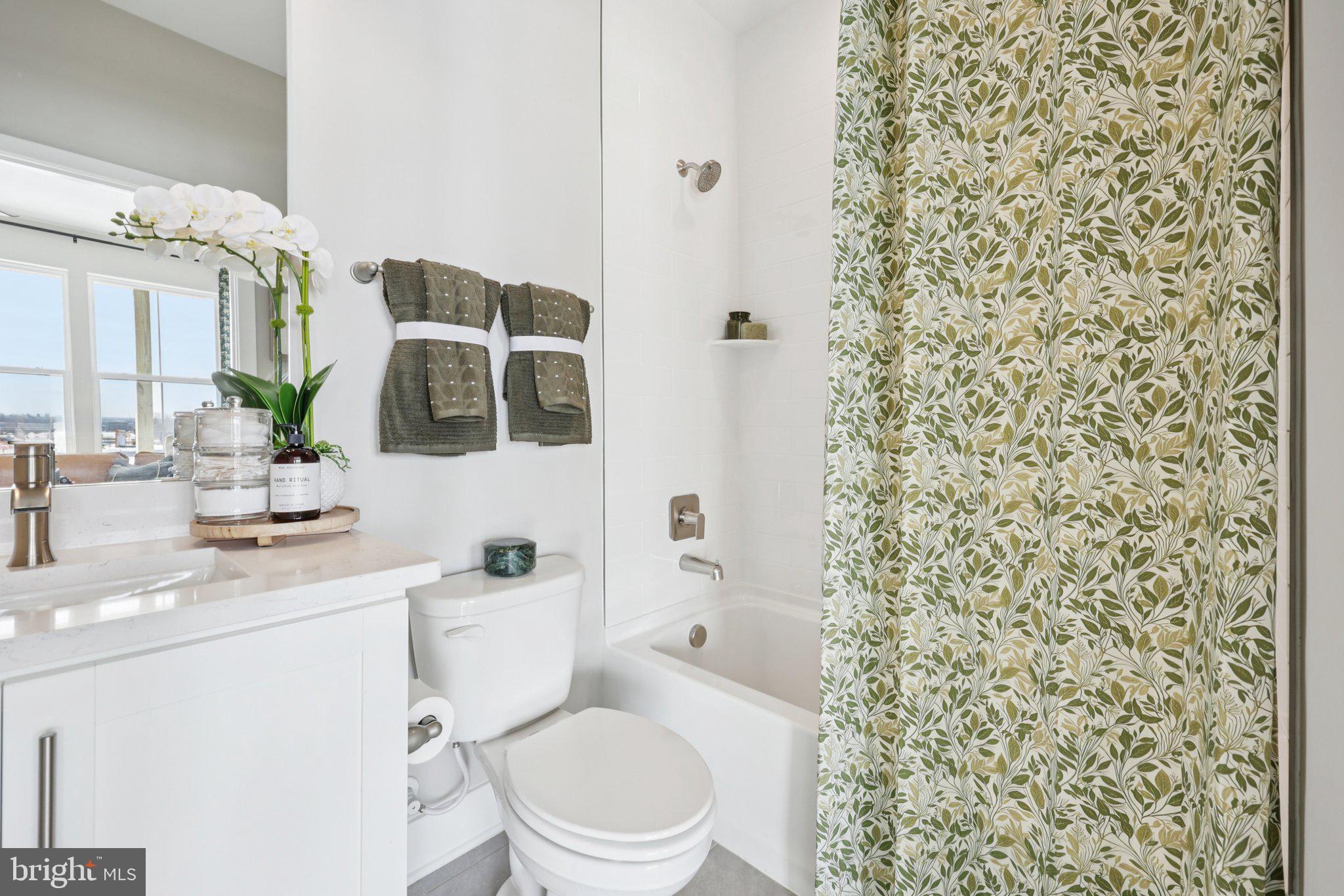 11361 Hypatia Loop Manassas, VA 20110 - Photo 19 of 55 a bathroom with a toilet a sink and a mirror