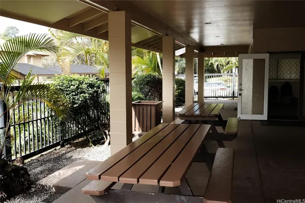 a view of a patio with a table chairs and a yard