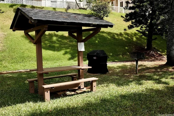 a view of a yard with a table and chairs